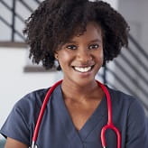 Portrait of female nurse wearing scrubs in hospital