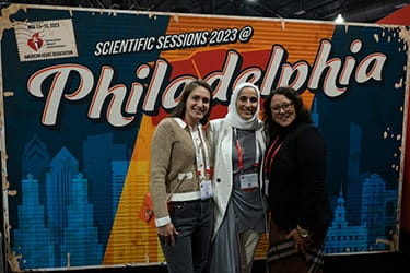 At Scientific Sessions 3 ladies posing in front of Philadelphia backdrop
